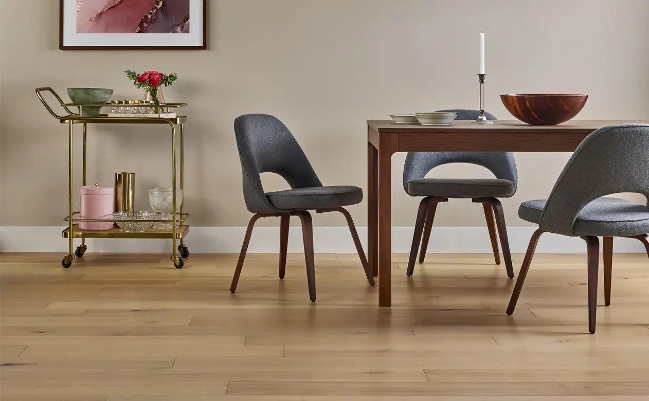 Light hardwood floors in casual kitchen with black seating 