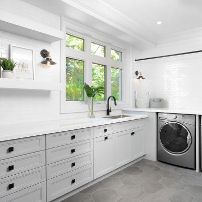 gray hexagon large format tile floor in combined laundry mudroom with sink